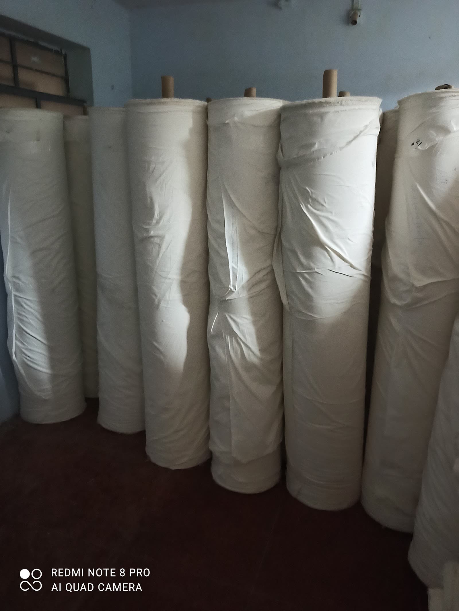 Export-ready greige rolls, packed and labelled.